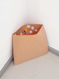 Dean Hughes, Stickers stuck inside a paper bag, 2019